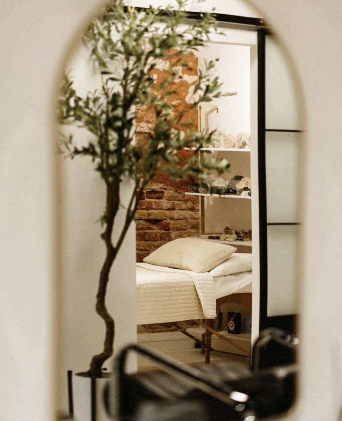 The Sage & Citrine healing room reflected in an arched mirror